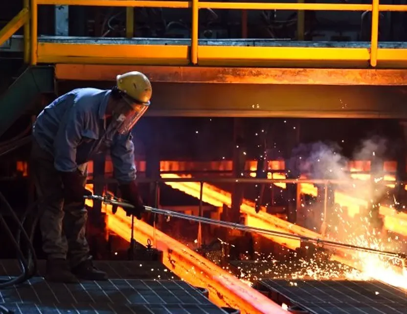 A worker melts metals in a furnace, recycling e scrap into valuable raw materials